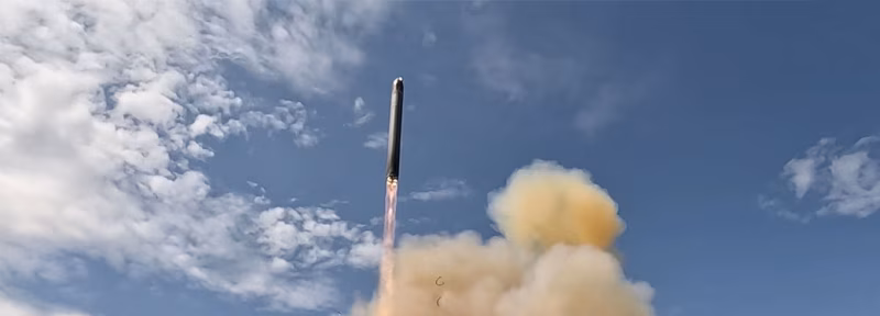RS-28 Sarmat ICBM lifting off during a test launch, surrounded by dust and exhaust clouds