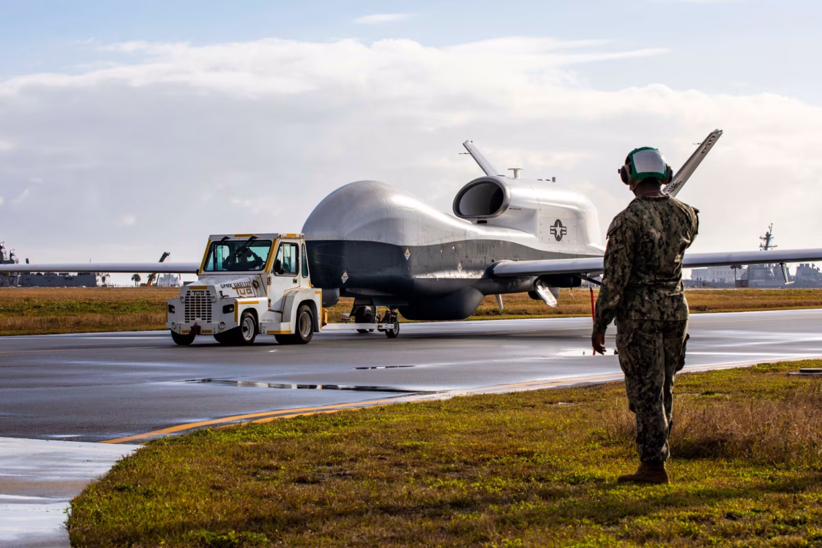 Triton drone preparing for takeoff with crew nearby