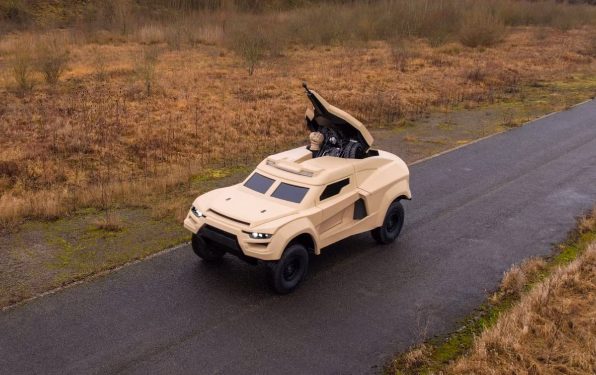 Cockerill i-X during Belgian trials, turret mid-deployment as the vehicle moves along a road