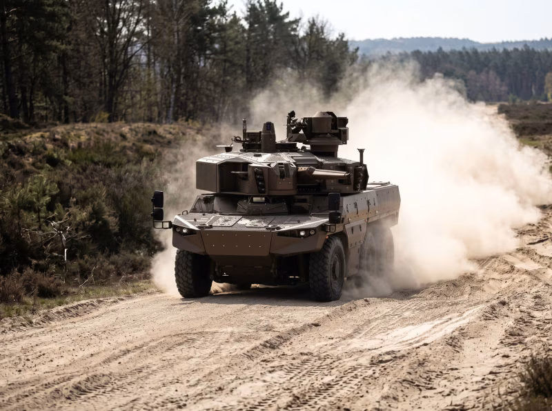 KNDS JAGUAR EBRC on a dirt track during trials, showing the 6x6 wheeled chassis and T40 turret kicking up dust at speed