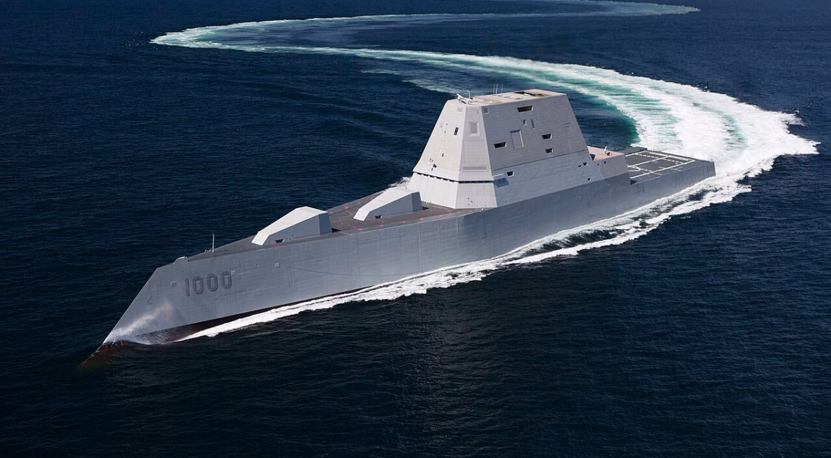 USS Zumwalt (DDG-1000) underway at sea during trials, showing the ship's distinctive tumblehome hull, angular composite deckhouse, and wave-piercing bow as it executes a hard turn.
