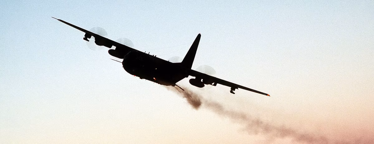 AC-130 firing its rotary cannon at twilight, 1988