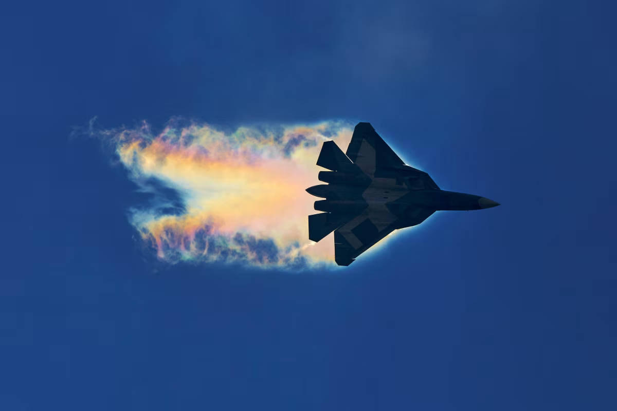Su-57 prototype trailing iridescent condensation vapor during a high-speed pass at MAKS-2015