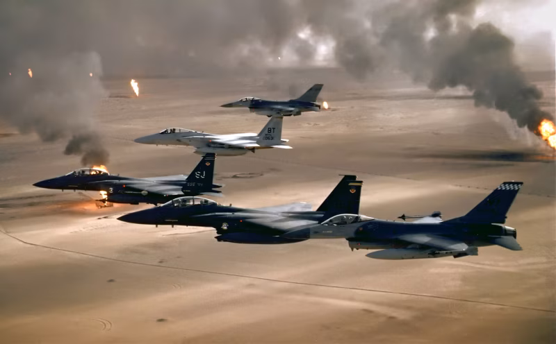 USAF F-16A, F-15C, and F-15E aircraft fly over burning Kuwaiti oil fields during Operation Desert Storm, 1991