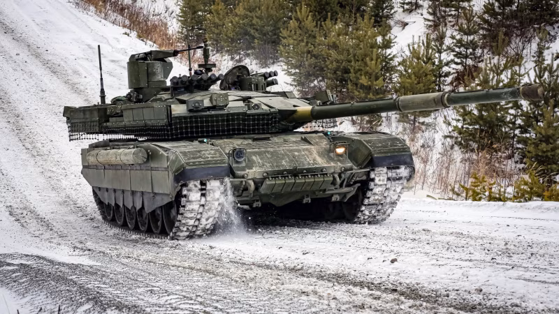 T-90M Proryv, the direct predecessor to the T-90M2 Ryvok-1. The bolt-on mesh armor visible here is the kind of field protection the T-90M2's integrated Arena-M APS is designed to replace permanently.