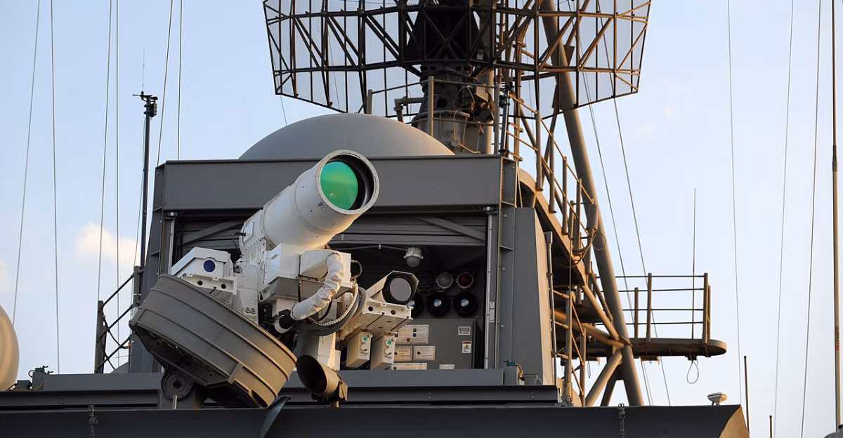 AN/SEQ-3 LaWS beam director mounted on USS Ponce superstructure, showing the green optical aperture and sensor arrays, November 2014