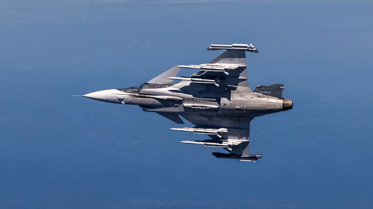 Gripen E serial 6002 seen from above showing full weapons loadout across all ten hardpoints