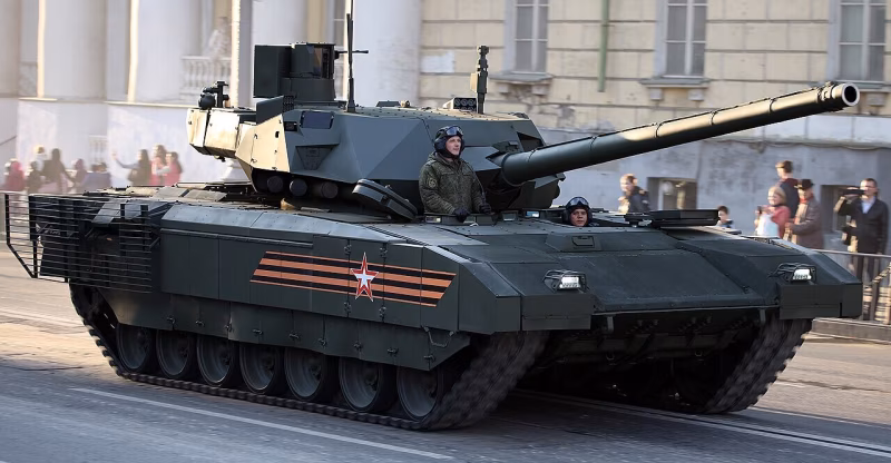 T-14 Armata main battle tank equipped with Afganit APS, featuring an angular armored turret and long smoothbore cannon, driving through a city street during a military parade rehearsal with crew visible in open hatches and spectators in the background.