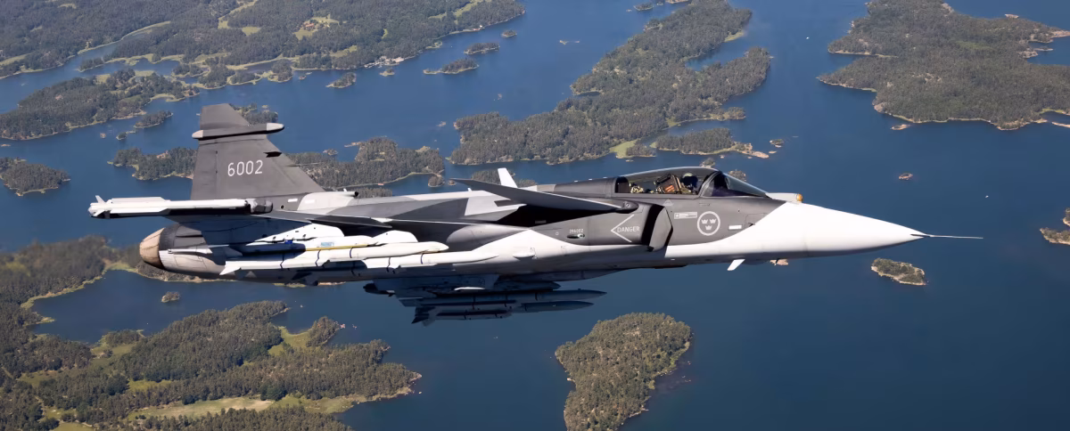 Saab JAS 39 Gripen E serial 6002 armed with missiles flying over the Swedish archipelago